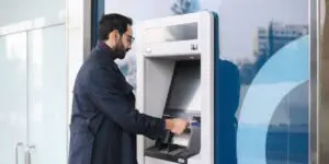 man using atm machine at an atm business