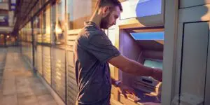 man using an atm outside