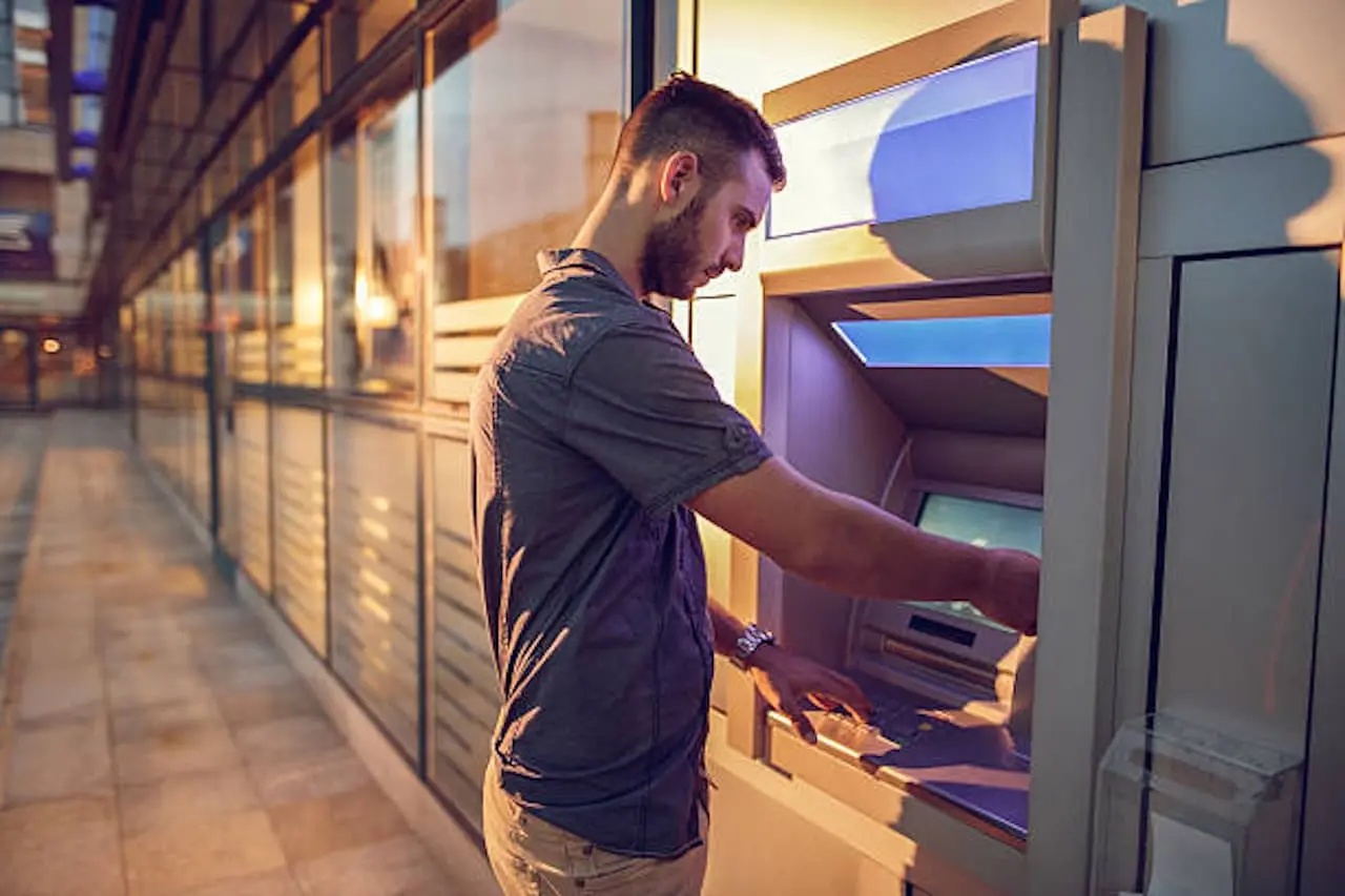 man using an atm outside