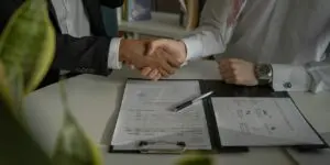 men shaking hands in aggreement for ATM business