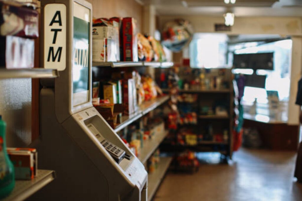 ATM machine inside a small local business American convenience store (bodega)